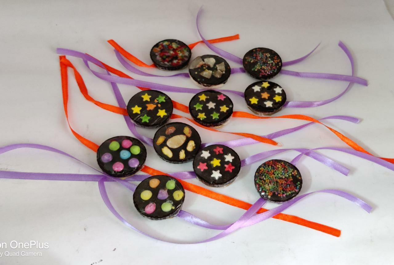 Handmade edible chocolate rakhis with ribbons — dry fruit, stars and sprinkle designs