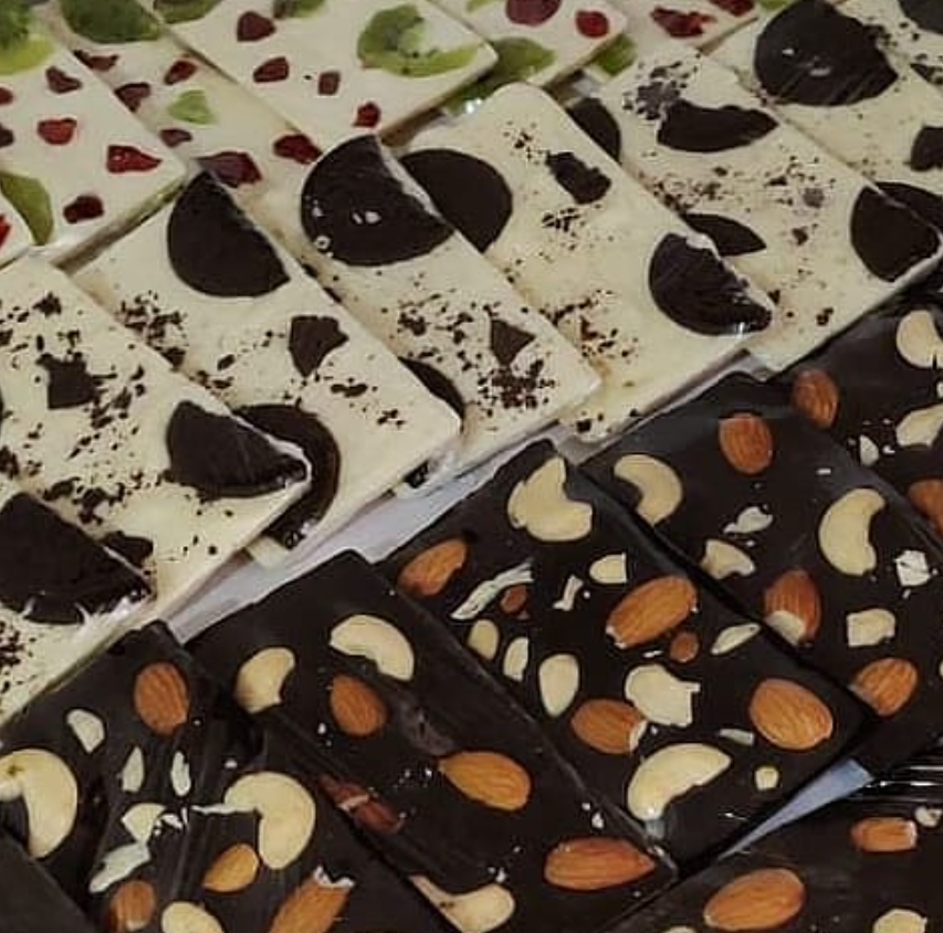 Handmade fruit and nut chocolate bark bars with almonds, cashews, oreo and kiwi