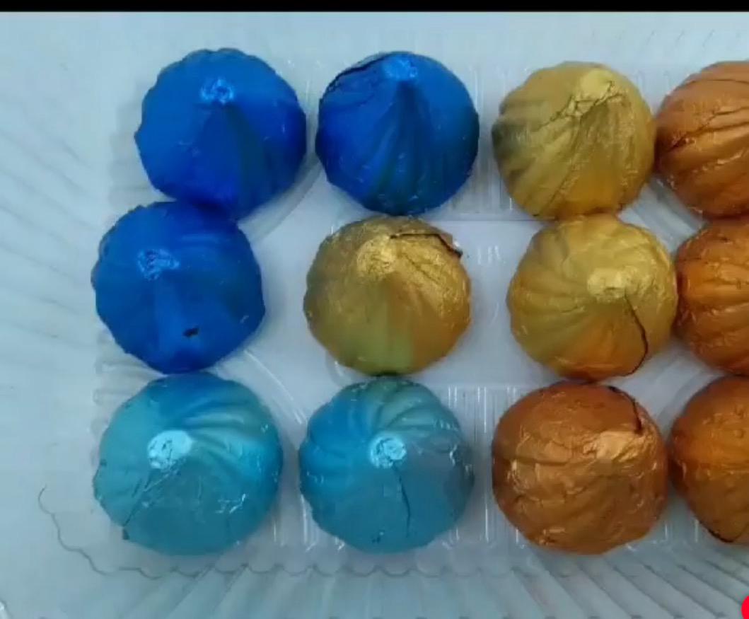 Premium foil wrapped dry fruit loaded chocolate modaks in blue, gold and copper